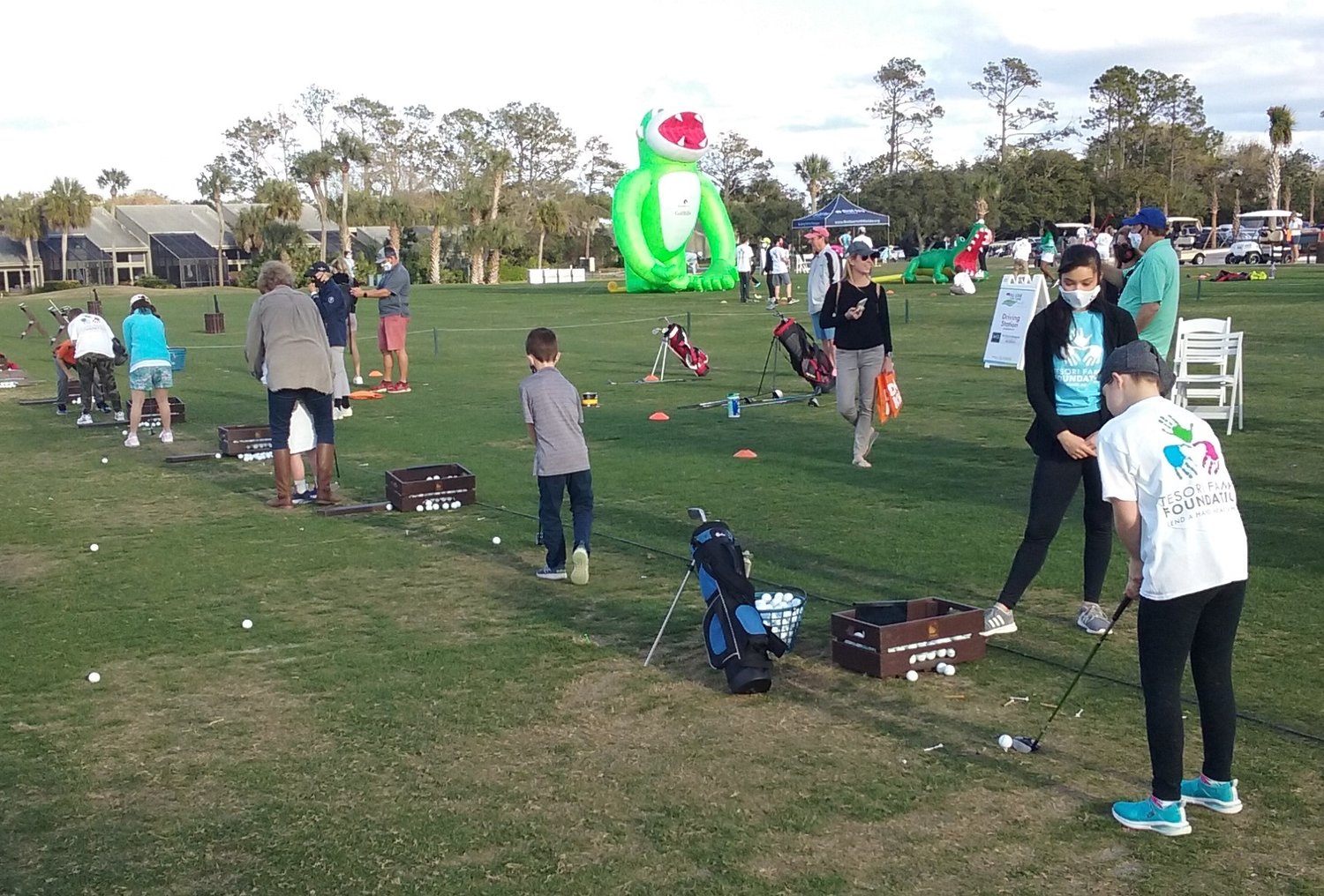 Young golfers line up along the driving range during the Tesori Family Foundation All-Star Kids Clinic on March 10.